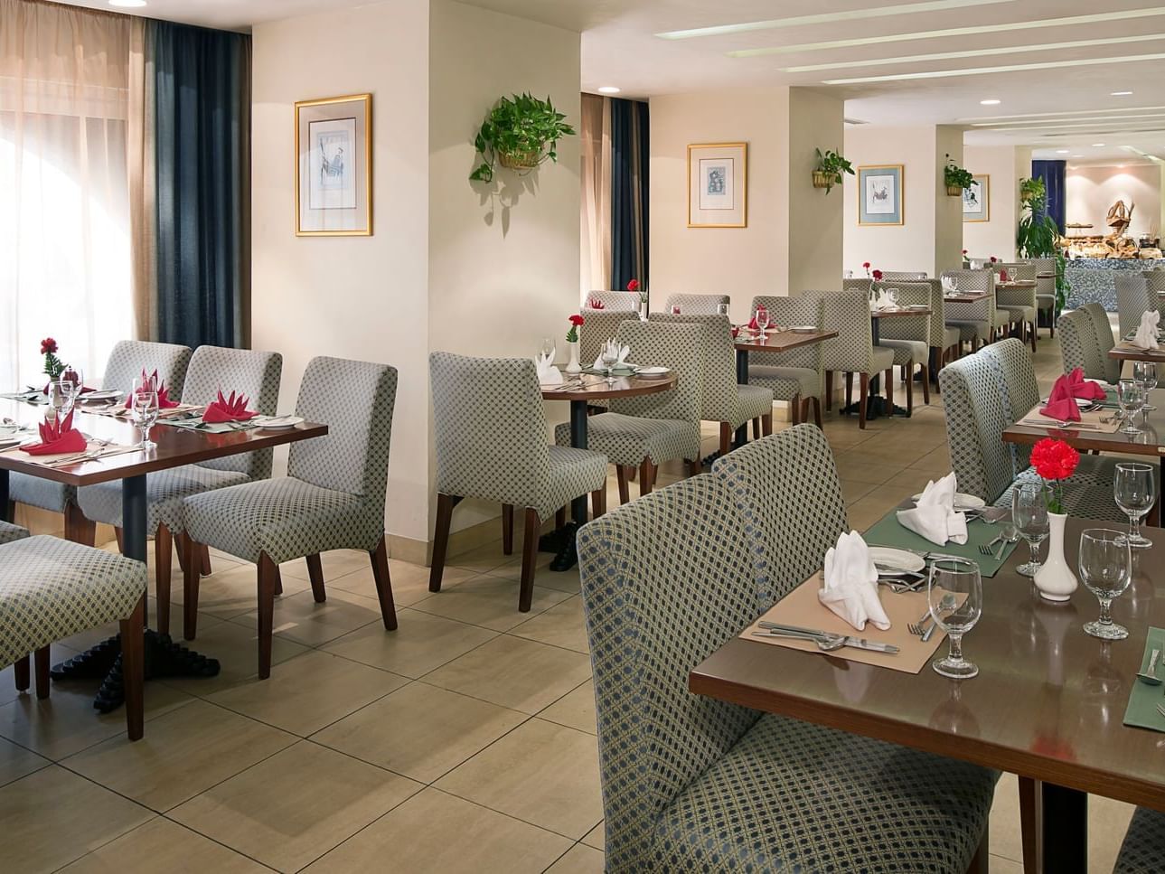 Table with cozy chairs in New Season at City Seasons Hotels