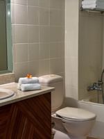 Bathroom of Superior Garden View Room with sink, toilet, and bathtub at The Naviti Resort Korolevu.
