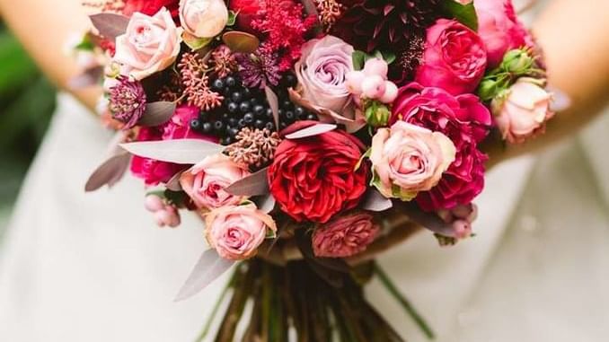 Vibrant bridal bouquet with deep red and blush pink roses for a wedding at The Sebel Mandurah