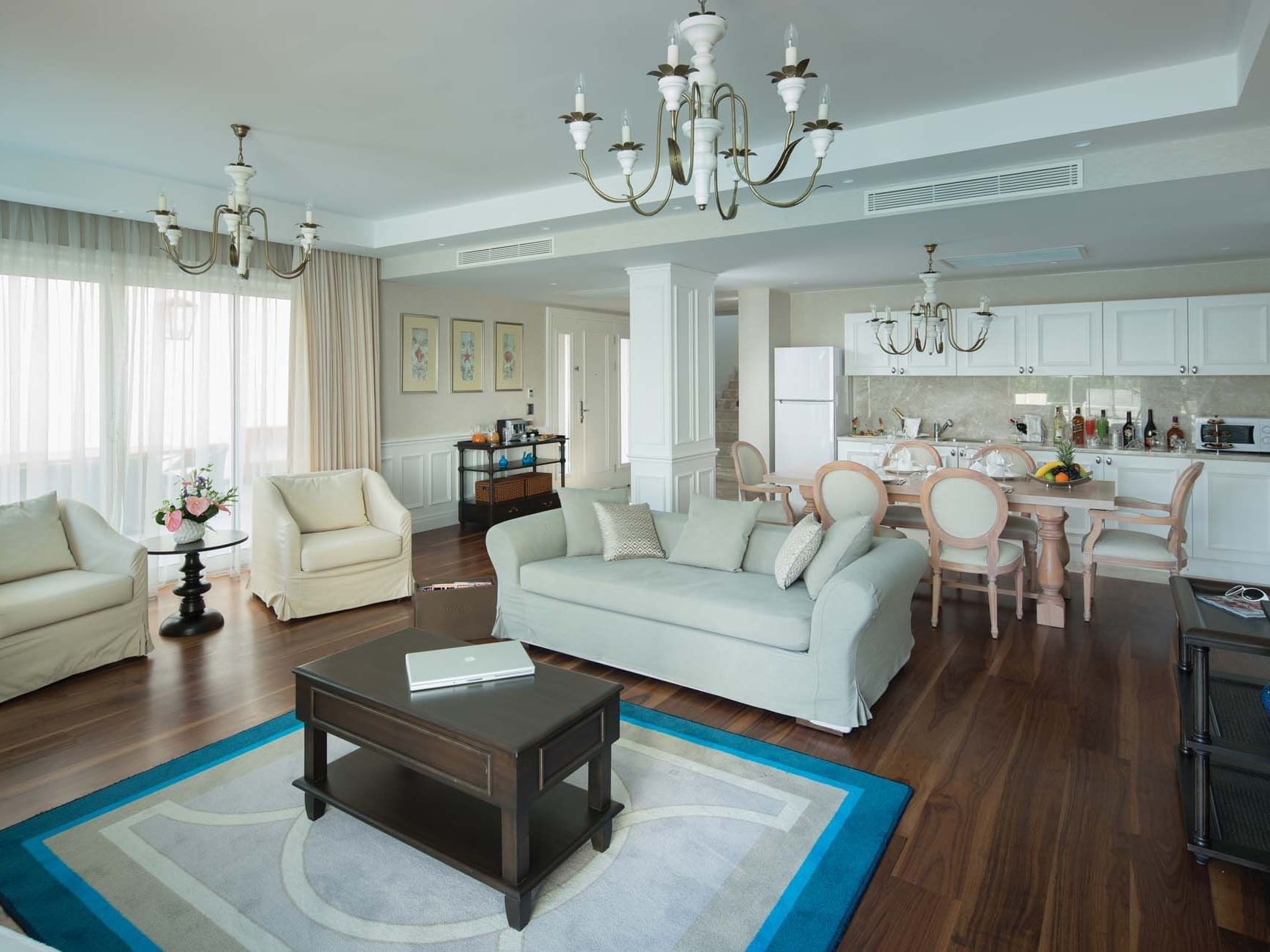 Dining area and living area in Superior Villa with wooden floors at Titanic Deluxe Golf Belek