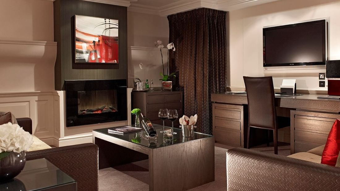 TV lounge area & fireplace in Apartment Suite at Guoman Hotels