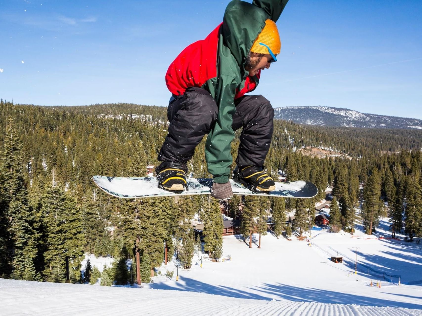 Man jumping with playing snowboard at Granlibakken Tahoe