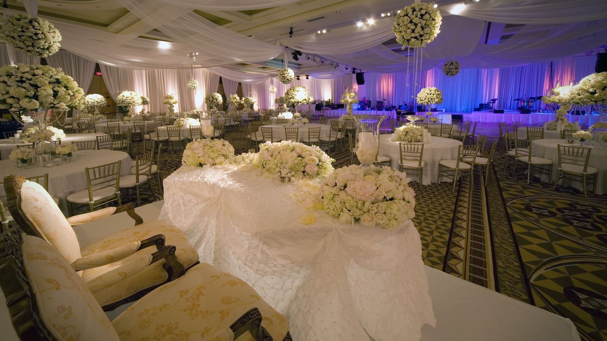 A wedding reception adorned with white flowers at The Diplomat Resort