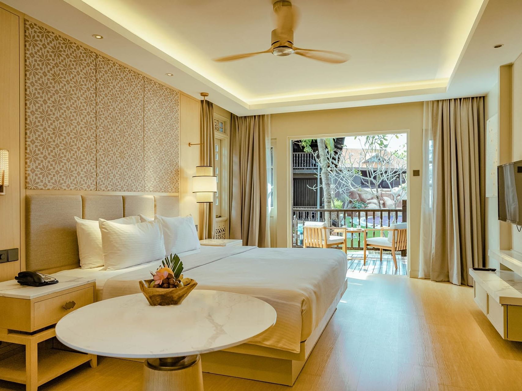Spacious bed & TV in Pool Terrace Room at Pelangi Resort