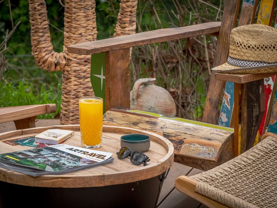 A juice on a outdoor table with magazines at Originals Hotels