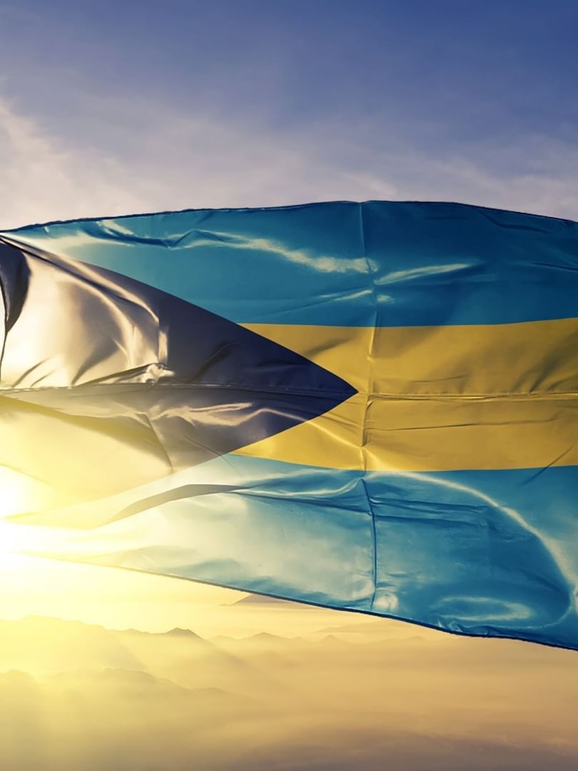 The Bahamas flag in the wind by a bright sun at Warwick Paradise Island Bahamas