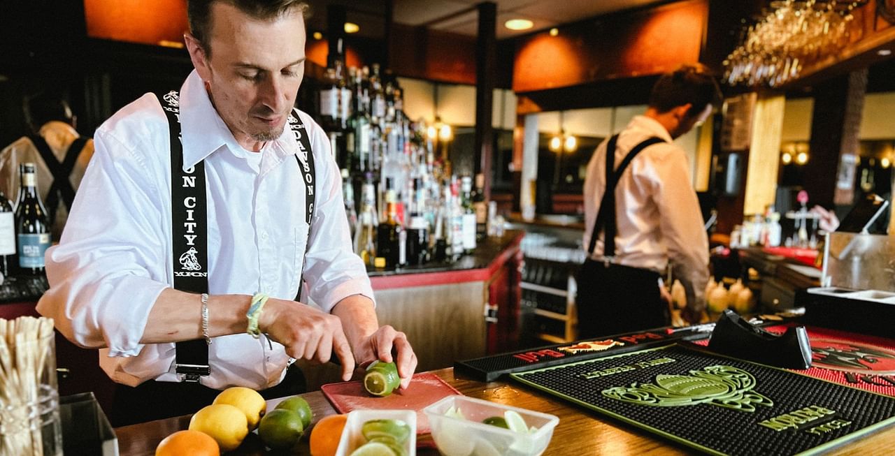 Bartender preparing a drink in Gallery Restaurant at Midnight Sun, a Coast Hotel