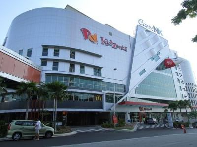 Aerial view of Kidzania with vehicles parked outside near One World Hotel