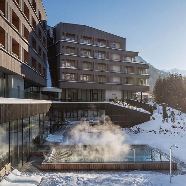 Distant exterior view of the Falkensteiner Hotel Schladming & the outdoor pool