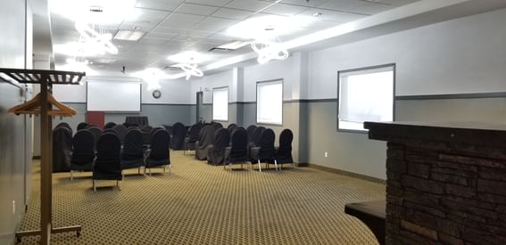 Black seating arranged with screen at Fort McMurray Hotel