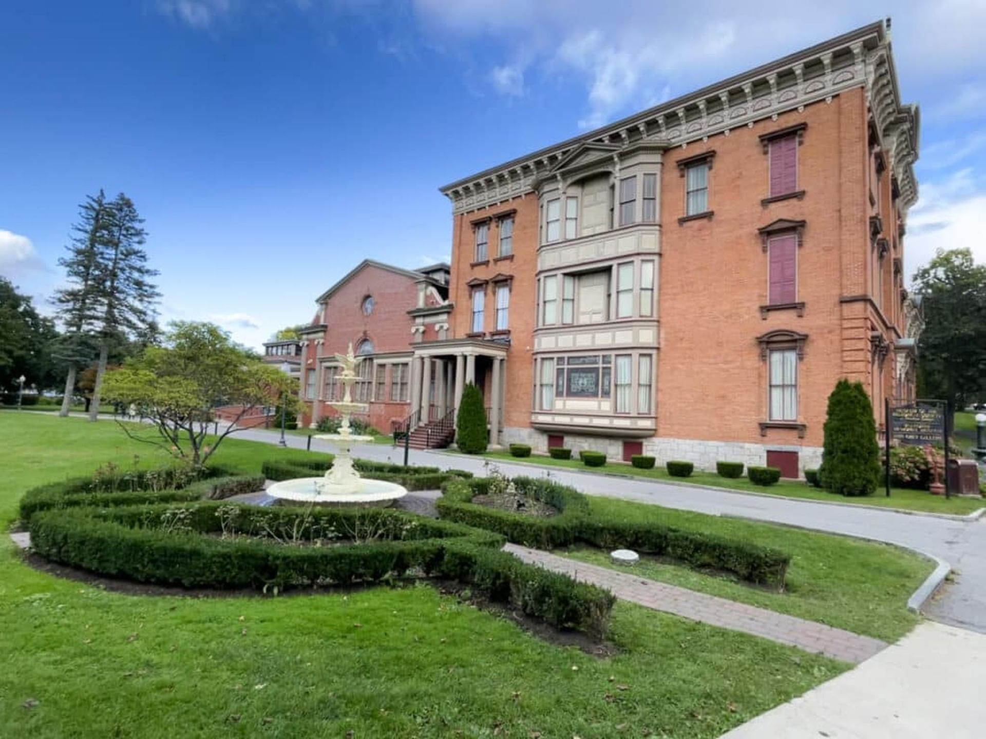 Exterior view of Saratoga Springs History Museum entrance and garden near Hotel Brookmere