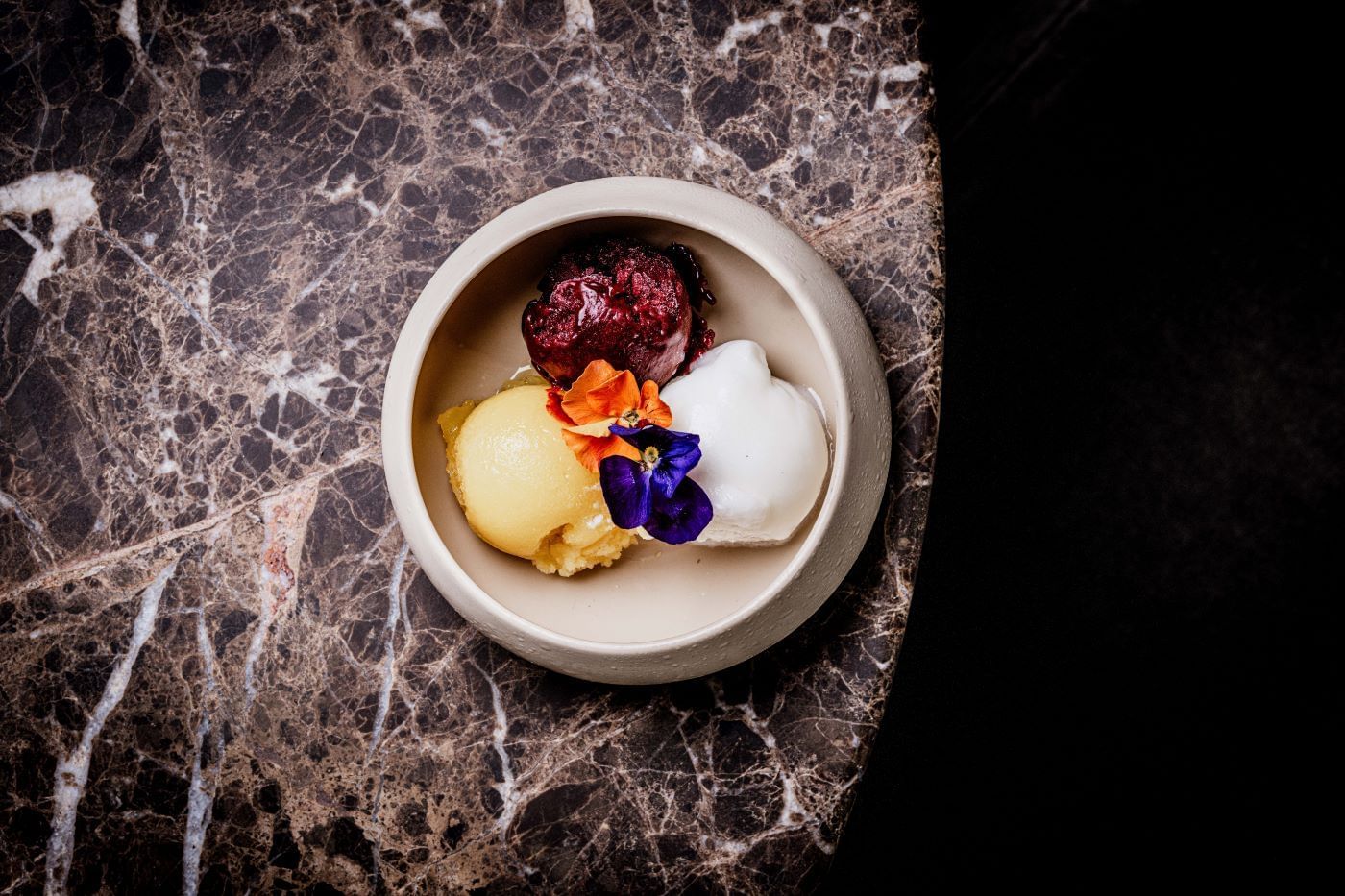 A bowl with a selection of sorbets from the By Day Menu at The May Fair Bar