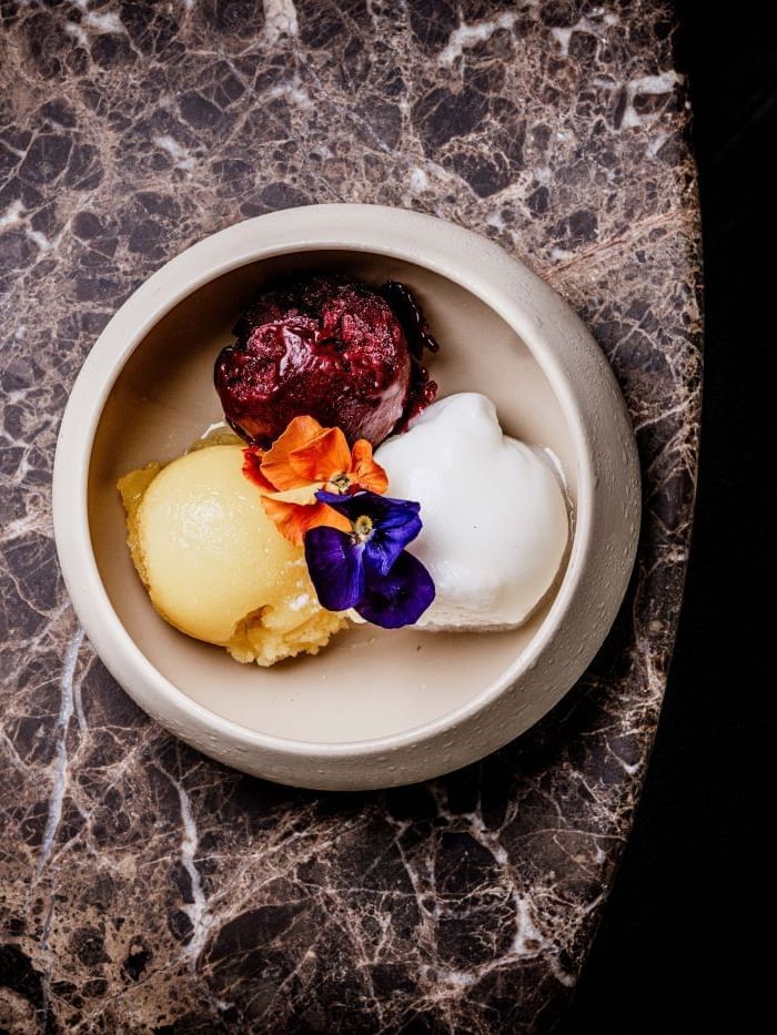 A bowl with a selection of sorbets from the By Day Menu at The May Fair Bar