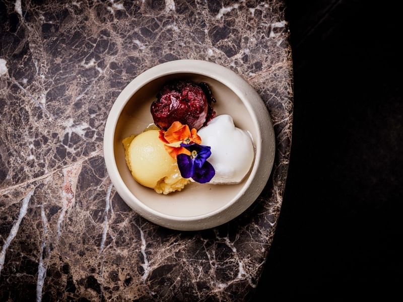 A bowl with a selection of sorbets from the By Day Menu at The May Fair Bar