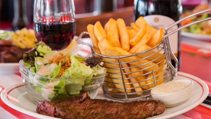 Closeup of meals served with wine at Hotel L'Acropole
