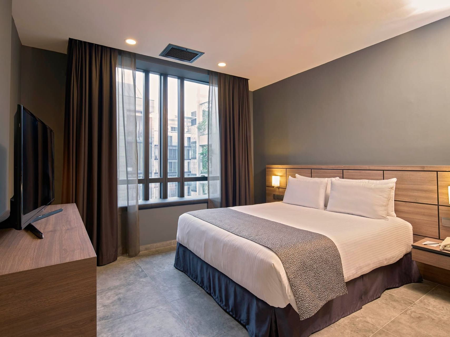 Image 71: Modern Two Bedroom with queen bed, sleek decor, TV, and soft natural light at Orchard Grand Court