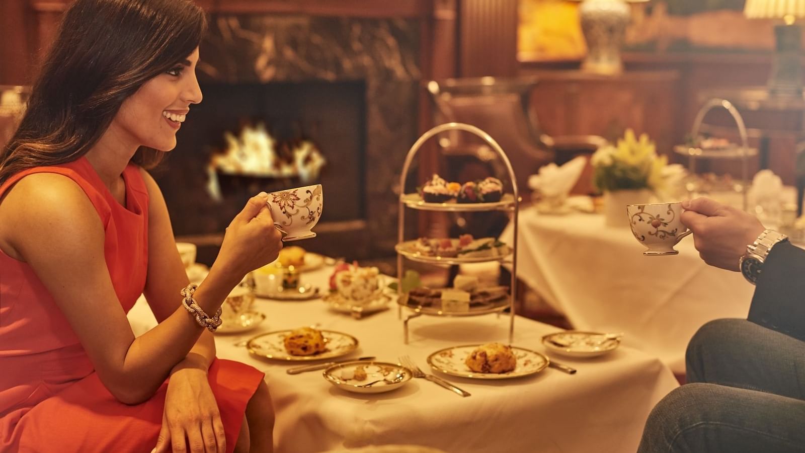 Couple having high tea by a fireplace at The Townsend Hotel