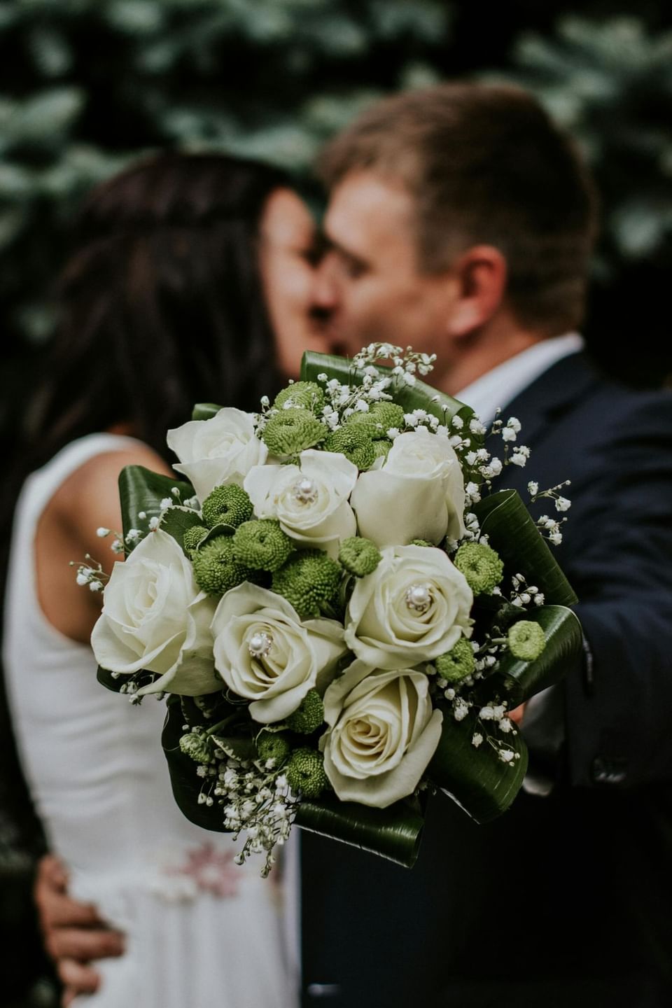 Close-up of a bouquet held by a couple against a softly blurred background at Ananea Madivaru Maldives