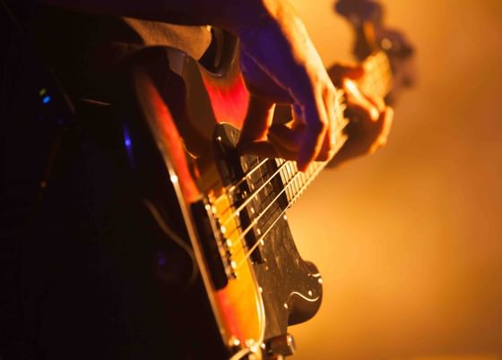 Close-up of man playing a guitar at The Danna Langkawi