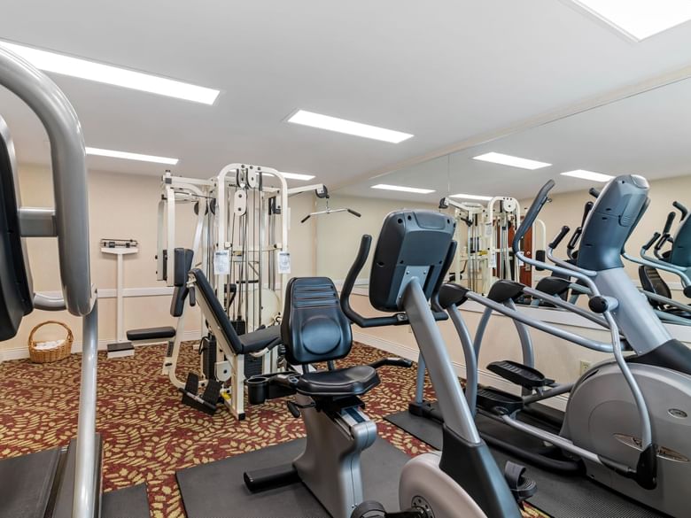 A gym with various exercise equipment