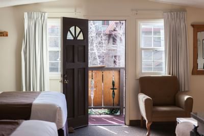 Room with two beds and door open at Alpenhof Lodge