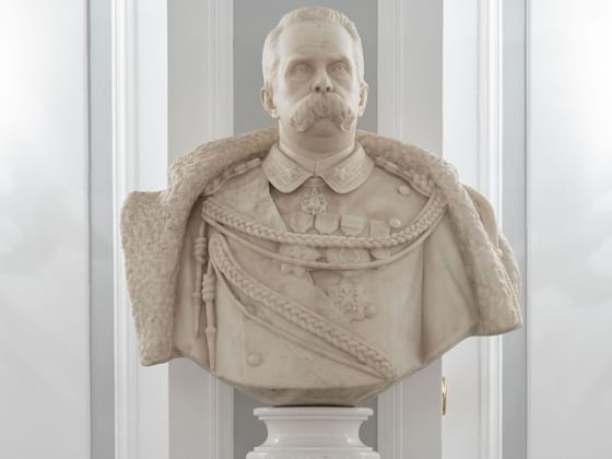 Close-up of a marble bust of a man in a room at Bettoja Hotels Group