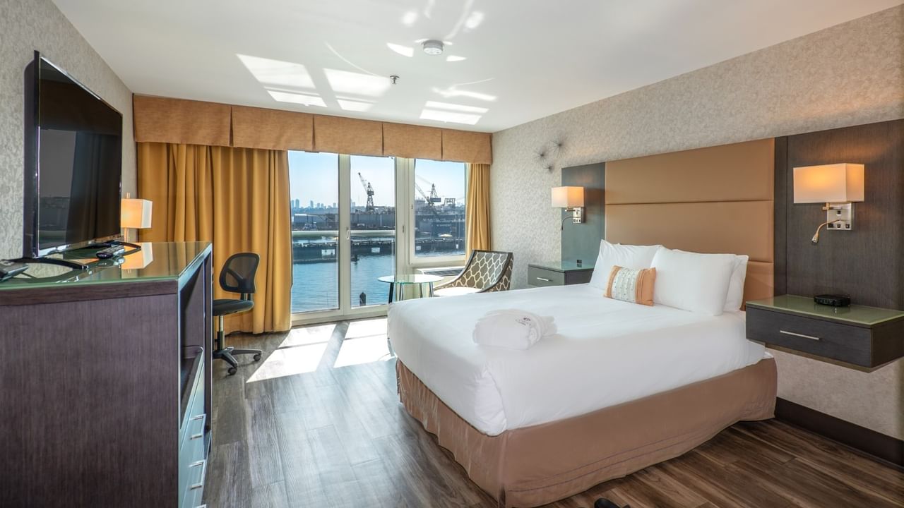 Coast Premium Queen with a queen bed, a balcony with a city view, and a flat-screen TV at Coast Lonsdale Quay Hotel