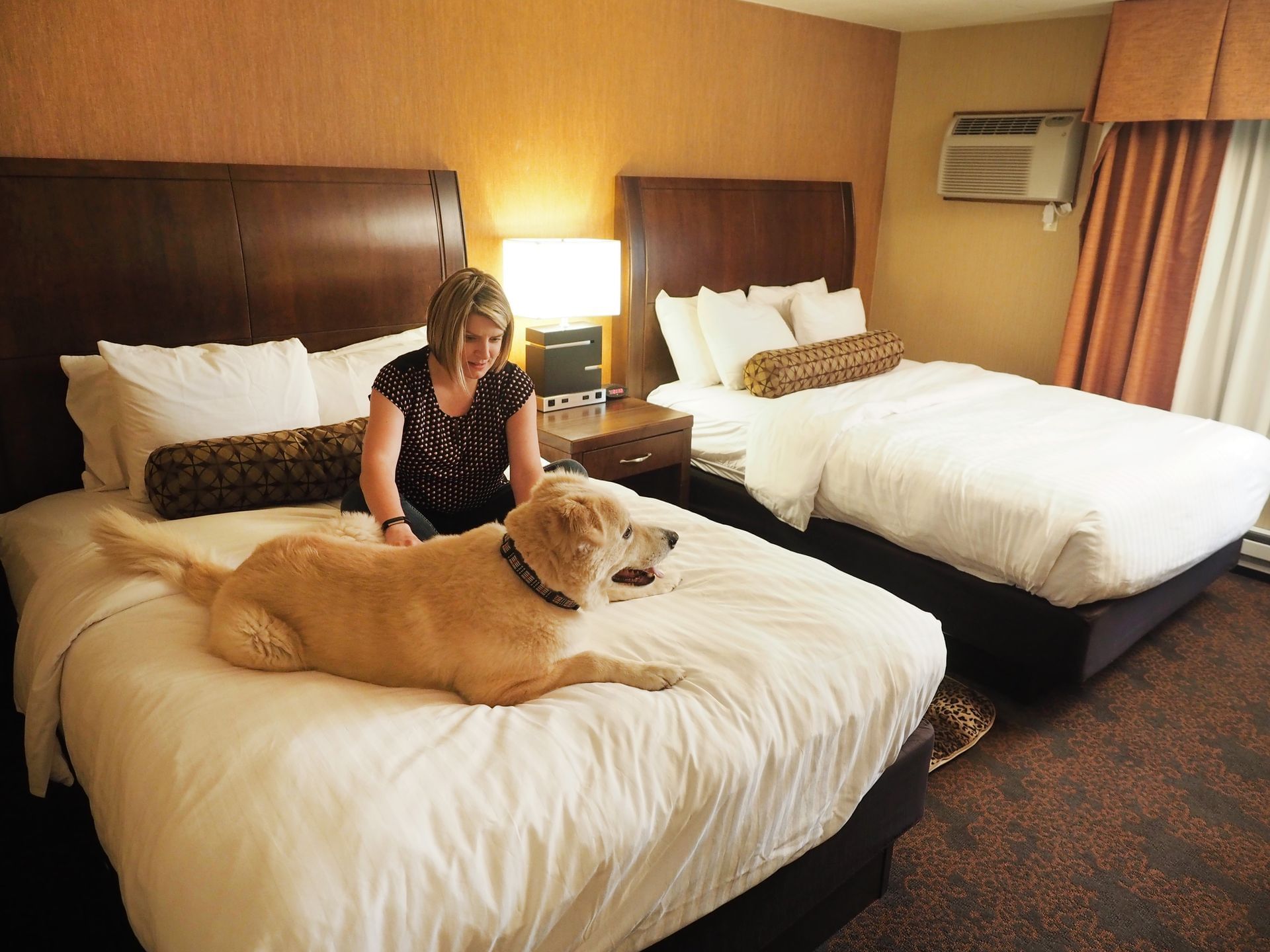 Woman & dog sitting in Pet Friendly Room at Evergreen Resort