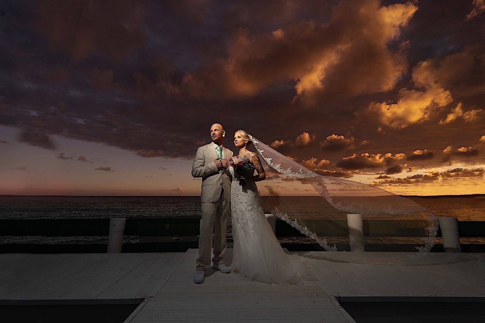 A wedding couple standing for a photoshoot at Copamarina