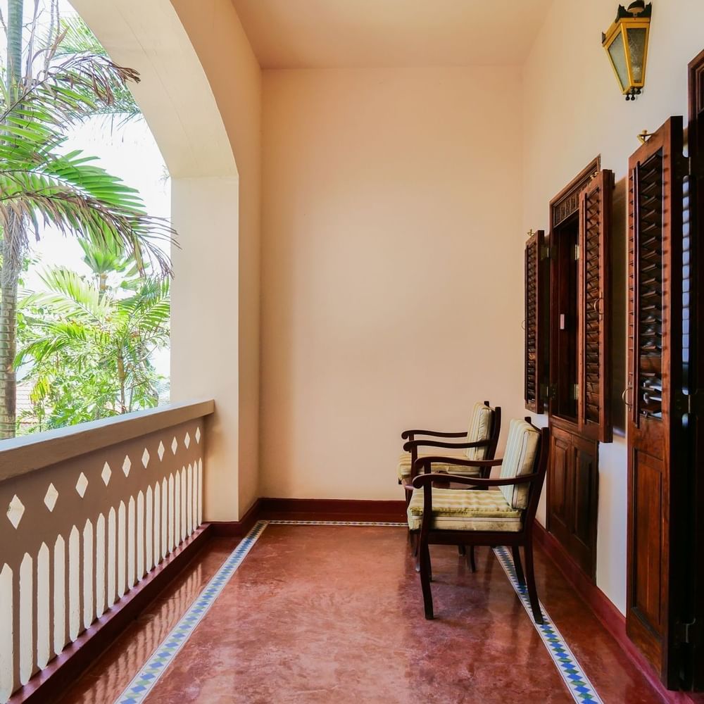 Executive Suite balcony with chairs and wooden shutters at Zanzibar Serena Hotel in Zanzibar.