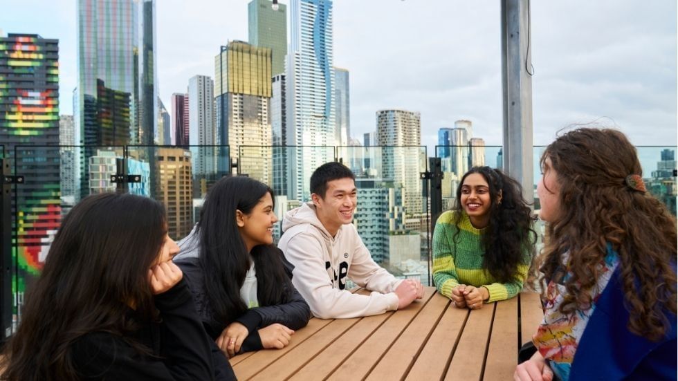 Students share their living experience at UniLodge Lincoln House with a city skyline backdrop.
