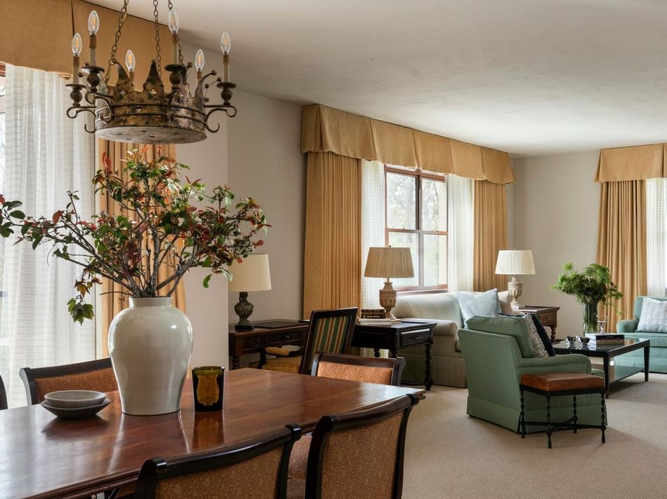 Living space with sofa and dining table in the Presidential Suite at Granduca Houston