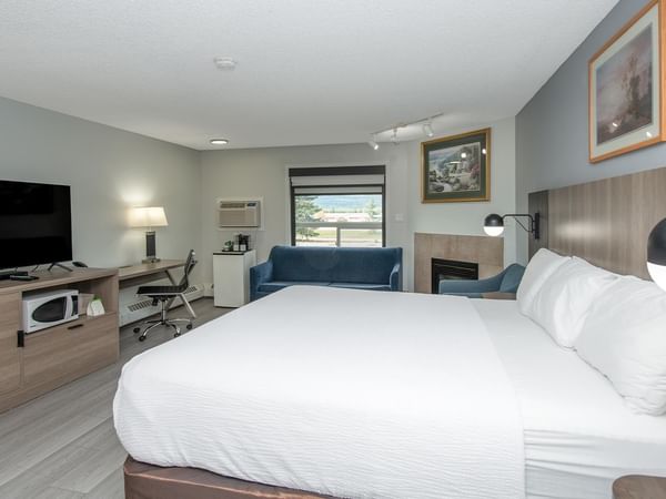 Spacious suite with king bed, work desk and modern amenities.