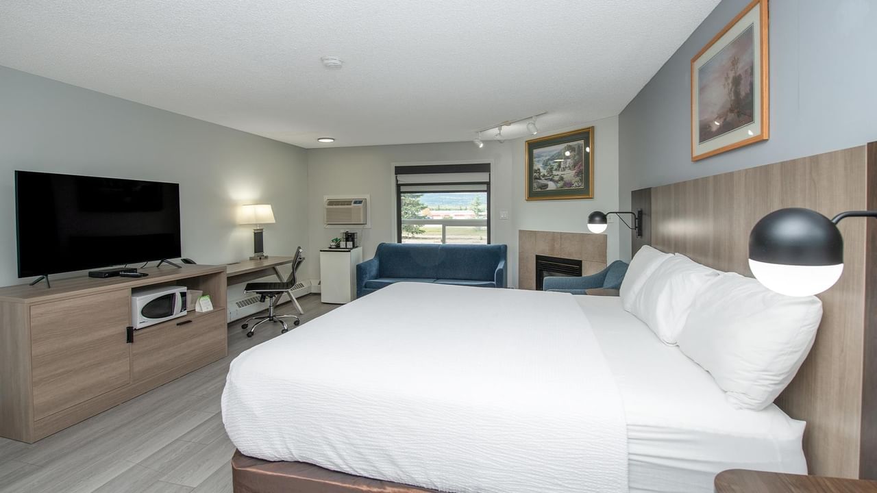 Spacious suite with king bed, work desk and modern amenities.