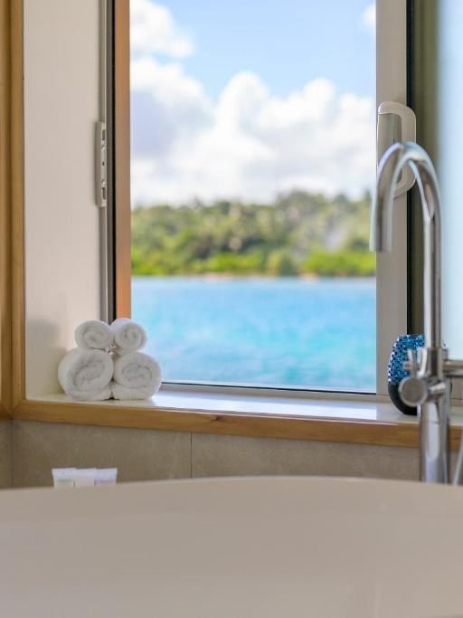 Overwater Villa bathroom with a view of the ocean at Warwick Le Lagon - Vanuatu, Efate.