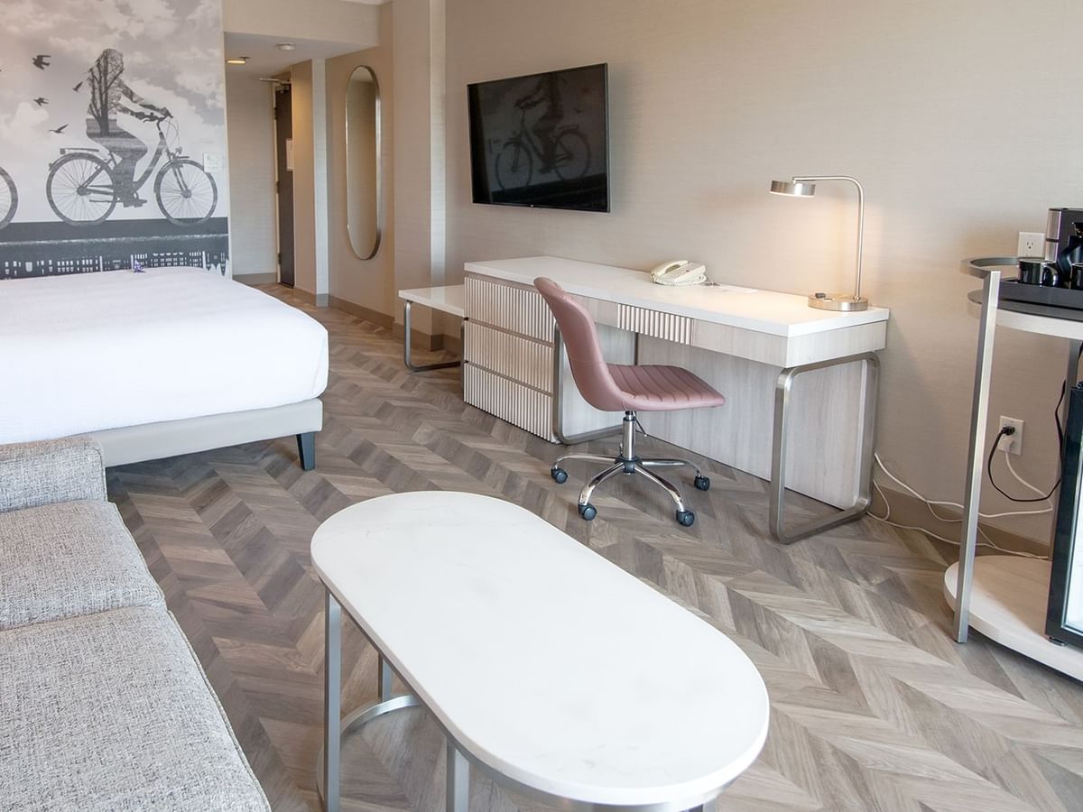 Hotel guestroom with king size bed, a sofa and coffee table