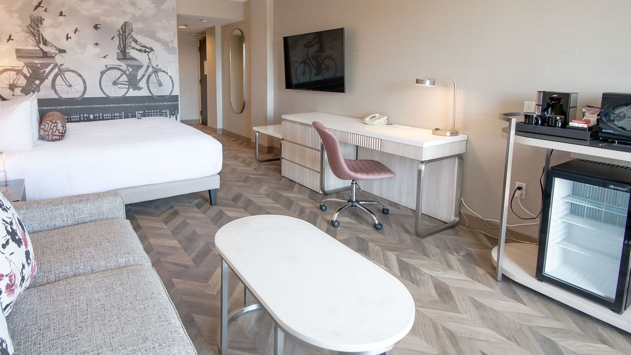 Hotel guestroom with king size bed, a sofa and coffee table