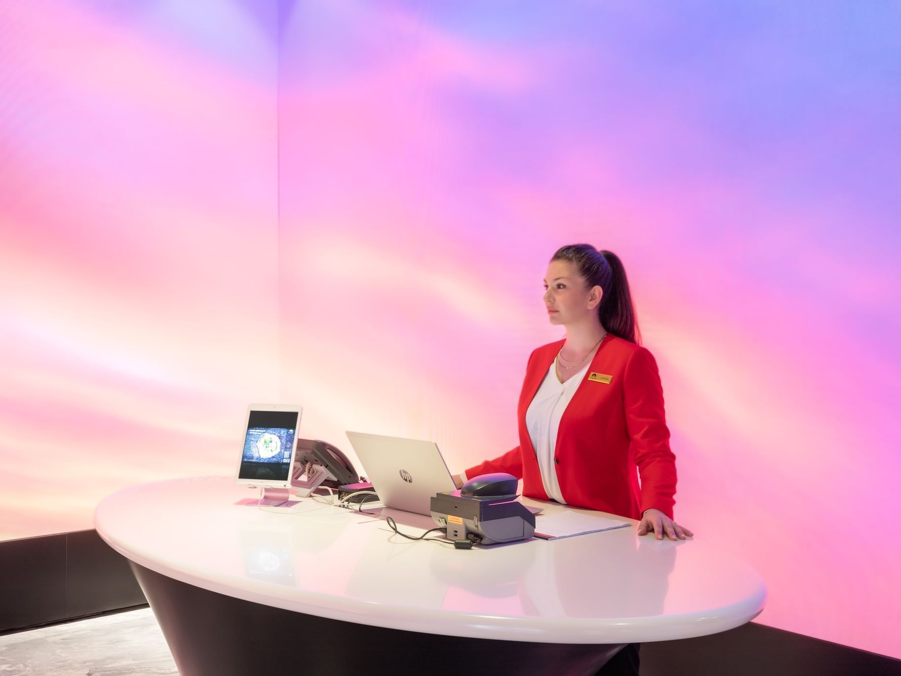 Receptionist posing by check-in & checkout desk at Paramount Hotel Dubai