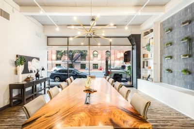Conference table set-up with artistic wall designs and wooden floors at The Riverwalk Plaza Hotel