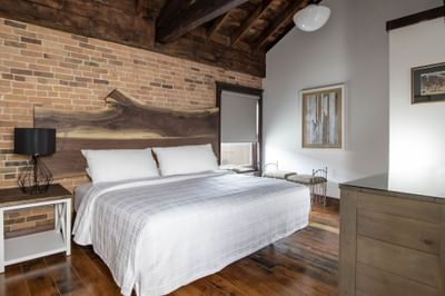 Large bed, nightstand & mirror in Apartment 402 at Retro Suites Hotel