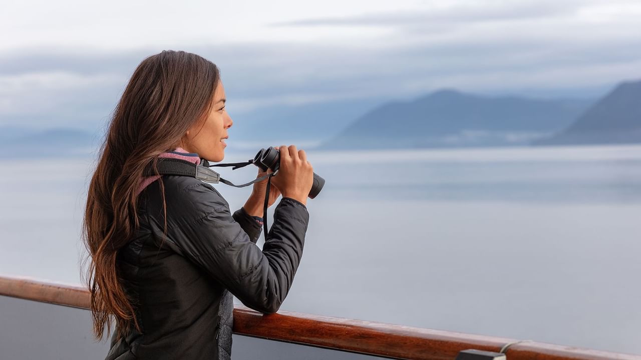 A woman whale watching from a boat
