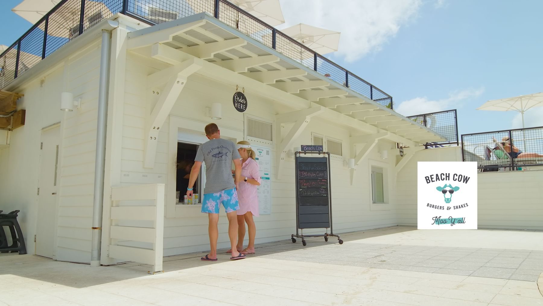 A couple by the Beach Cow at WaterColor Beach Club