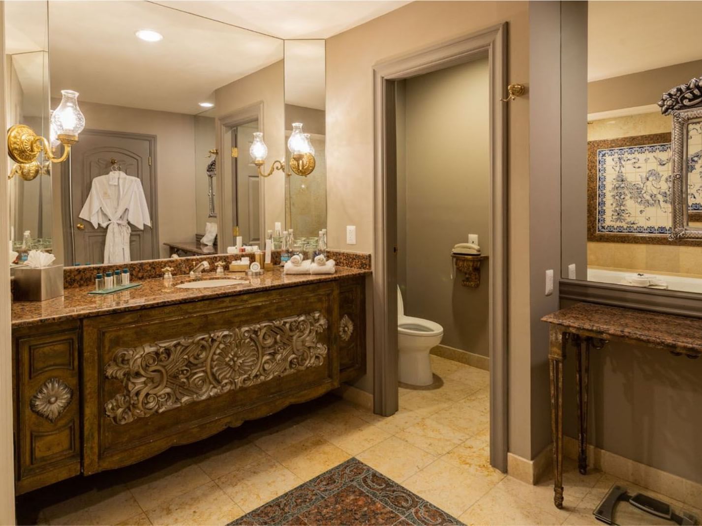 Luxury vanity in King Executive Tower showcasing intricate wood carvings and a large wall mirror at Quinta Real Monterrey