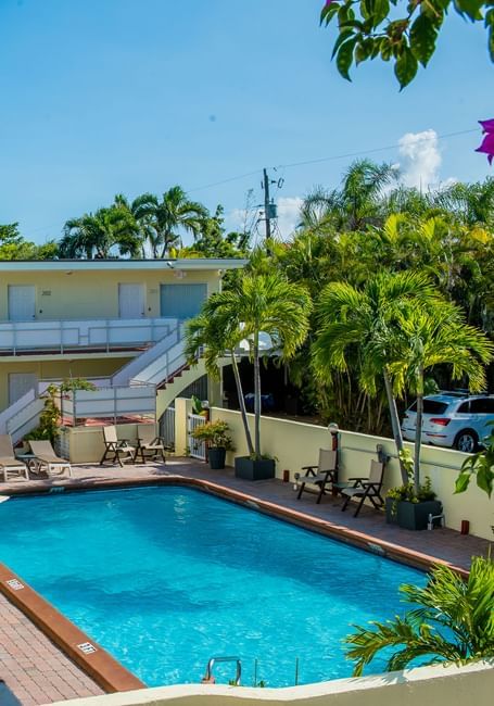 Outdoor pool area with arranged loungers at Ocean Lodge Boca Raton