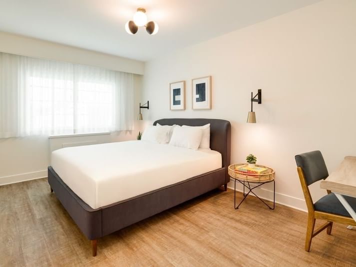 Bedroom King with sheer curtains, warm lighting, and modern decor details at Kenmore Village Hotel South Beach