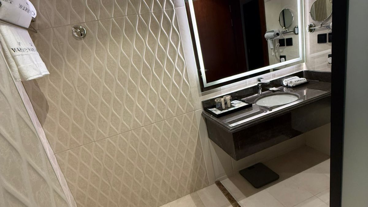Ambassador Suite bathroom featuring a vanity with an integrated sink under a mirror at Warwick Jeddah Hotel & Spa