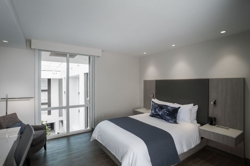 Comfy bed & pillows in Queen Guest room at Innovation Hotel