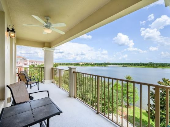 Private balcony with lake views and seating area in Premium Lakeview 3 Bedroom/ 2 Bath Condo at Vista Cay Resort By Millenium