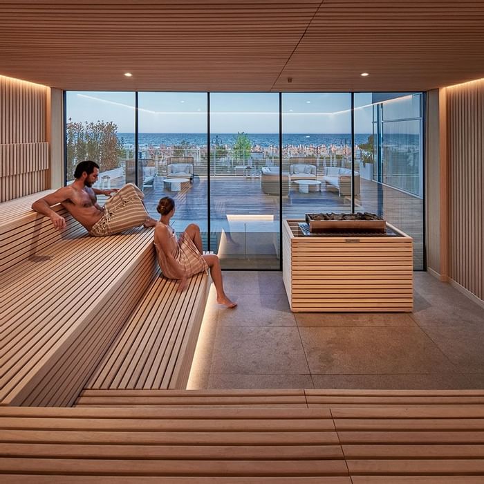 Couple lounging, sauna spa at Falkensteiner Residences Jesolo