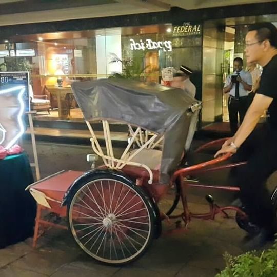 A Cycle rickshaw parked near Federal Hotels International
